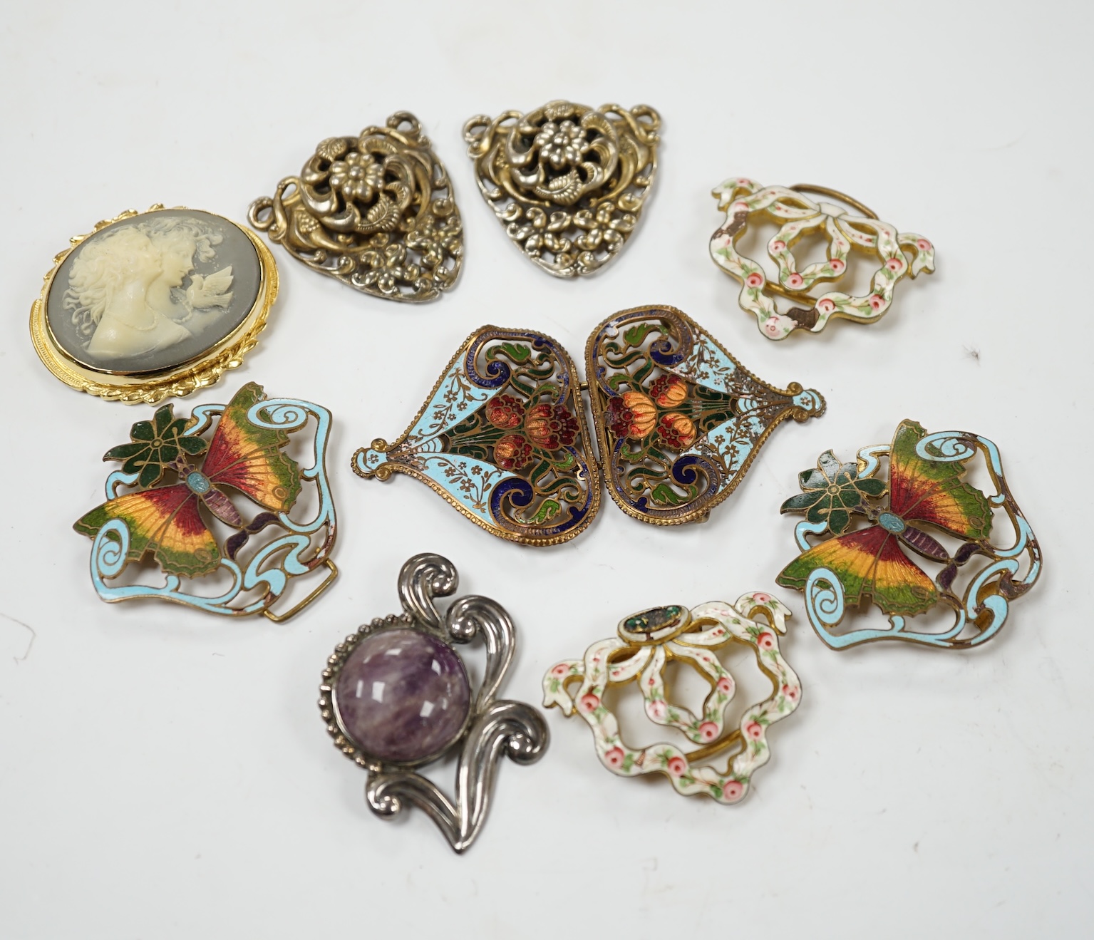 A Mexican Los Castillo sterling and cabochon amethyst set foliate brooch, 60mm, a small collection of base metal and cloisonné enamel belt buckles and a cameo brooch. Condition - poor to fair